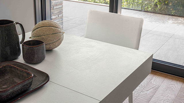 Brooklyn Mini table in transition, showing its sleek extension mechanism with a close-up on the tabletop.