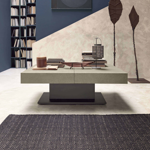 Modern living room featuring the Ceres table in a minimalist design, surrounded by a built-in bookshelf and contrasting wall textures.