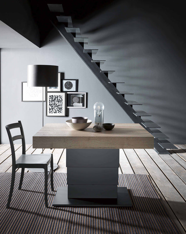 Compact and versatile, the Ceres Liscia table shown in a stylish setting with contemporary art and furniture.