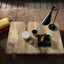 Cristallo Maxi table with a natural wood finish, seen from above with decorative accessories and soft lighting.