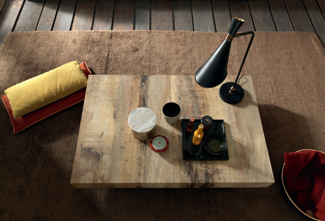 Cristallo Maxi table with a natural wood finish, seen from above with decorative accessories and soft lighting.