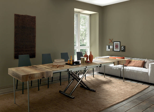 Cristallo Maxi table extended to full dining table size, featuring a wood grain top and seating arrangement in a modern home.