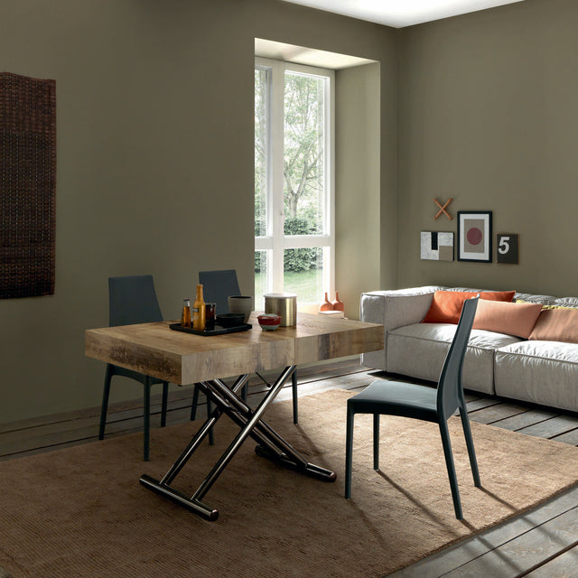 Cristallo Maxi table configured as a compact dining table with metal base, complementing a cozy and stylish living room.