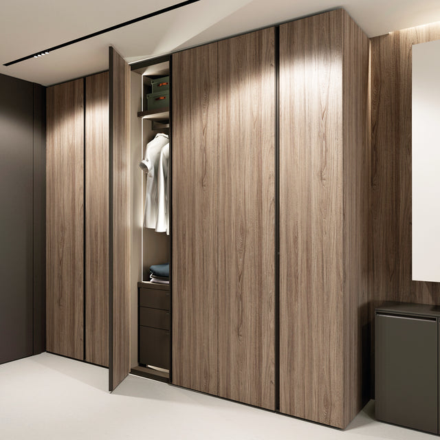 Open wardrobe system in a wood finish showcasing hanging storage and integrated compartments for a clean, modern look.