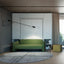 Sophisticated space with a bold green upholstered sofa in front of a hidden Murphy bed, paired with minimalist cabinetry and integrated bookshelves.