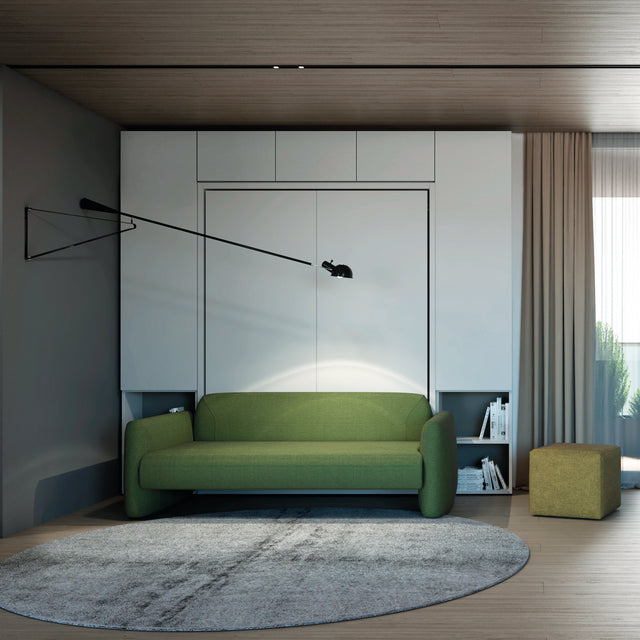 Sophisticated space with a bold green upholstered sofa in front of a hidden Murphy bed, paired with minimalist cabinetry and integrated bookshelves.