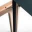 Close-up of Amalong extension dining table’s patented rotating mechanism with black tabletop and ash wood leg.