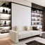 Atena Vertical wall bed with sofa closed in a contemporary living room with integrated shelving.