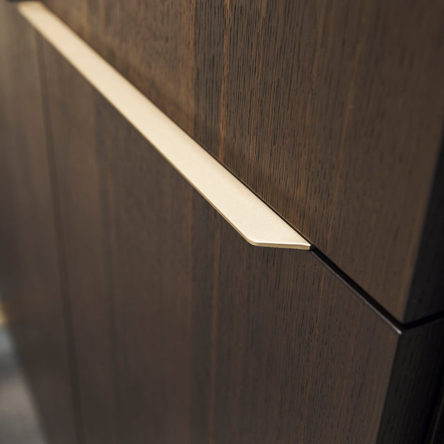 Close-up view of exclusive handle design on wood finish custom entryway cabinet – space saving furniture by Resource Furniture.