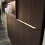 Close-up of custom entryway cabinet in wood finish with exclusive handle detail – space saving furniture by Resource Furniture.