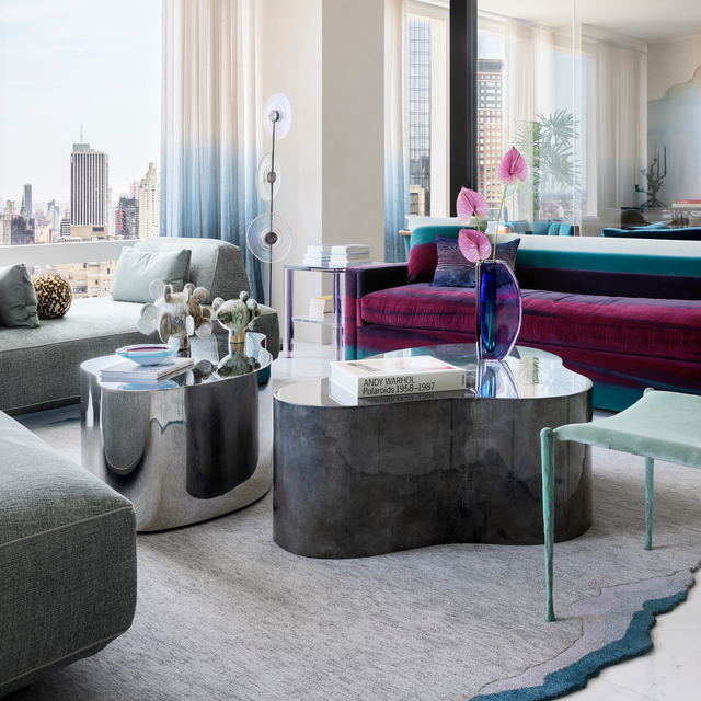 Detail view of modern NYC living room with Flex modular sofa, sculptural coffee tables, and velvet accent seating, designed by Peti Lau.