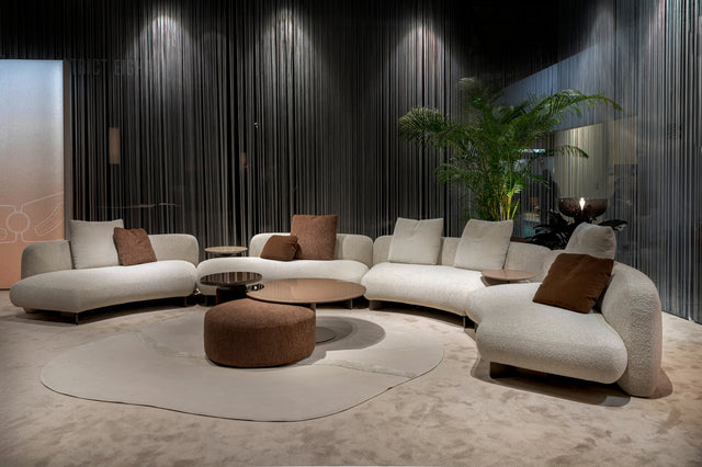 Kintai modular curved sectional sofa in cream and brown upholstery by Resource Furniture, featuring deep seating and sculptural lines.