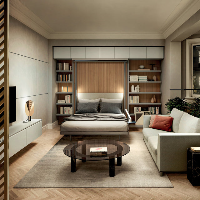 LGM Murphy bed (Resource Furniture) open in a modern living room with wood-paneled back, gray upholstered headboard, integrated white shelving and overhead cabinets, pulled-down bed with neutral bedding beside a sofa and glass coffee table — space-saving, multifunctional furniture.