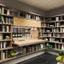 Maxi Bar open as a concealed home bar integrated into a custom library wall system with shelving and barware.