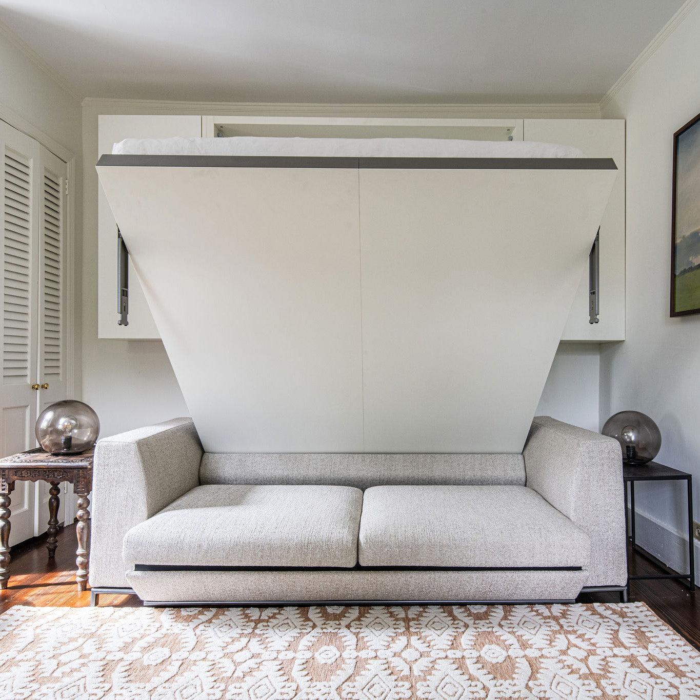 Tonale Murphy bed with sofa shown in transition from upright to open position, highlighting space saving furniture with multifunctional design.