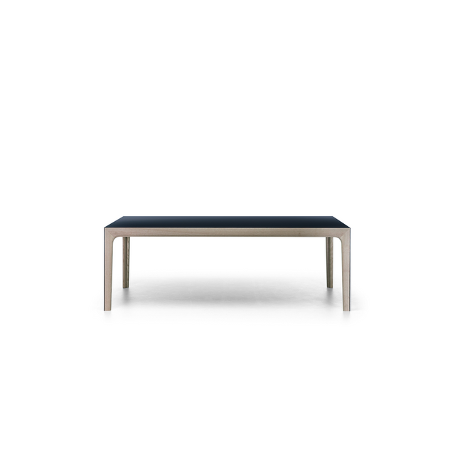 Amalong extension dining table in compact position with black top and light ash wood base, against white background.