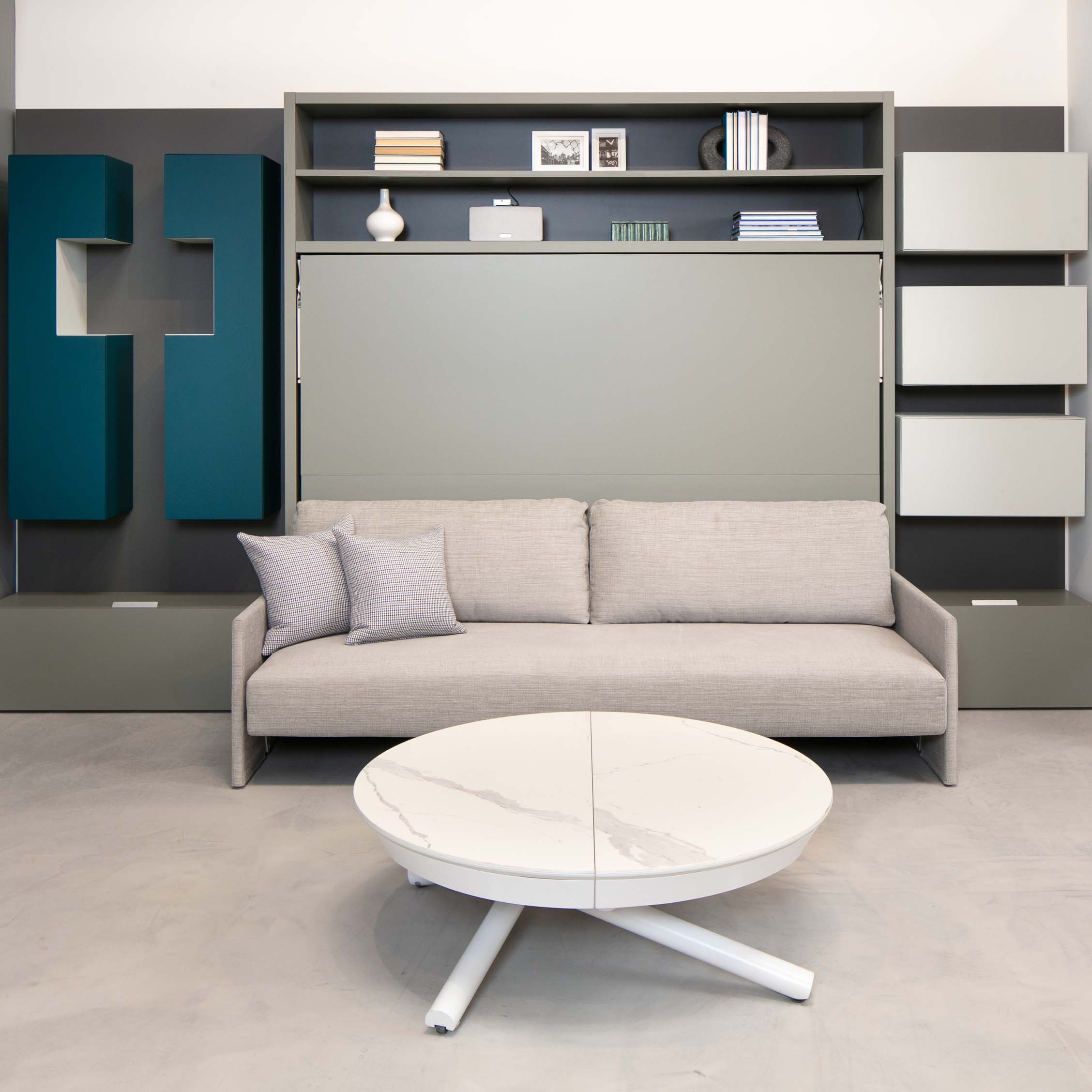 Circe Sofa horizontal queen wall bed with couch in a modern showroom, featuring integrated shelving and minimalist decor – space saving Murphy bed with sofa for small spaces