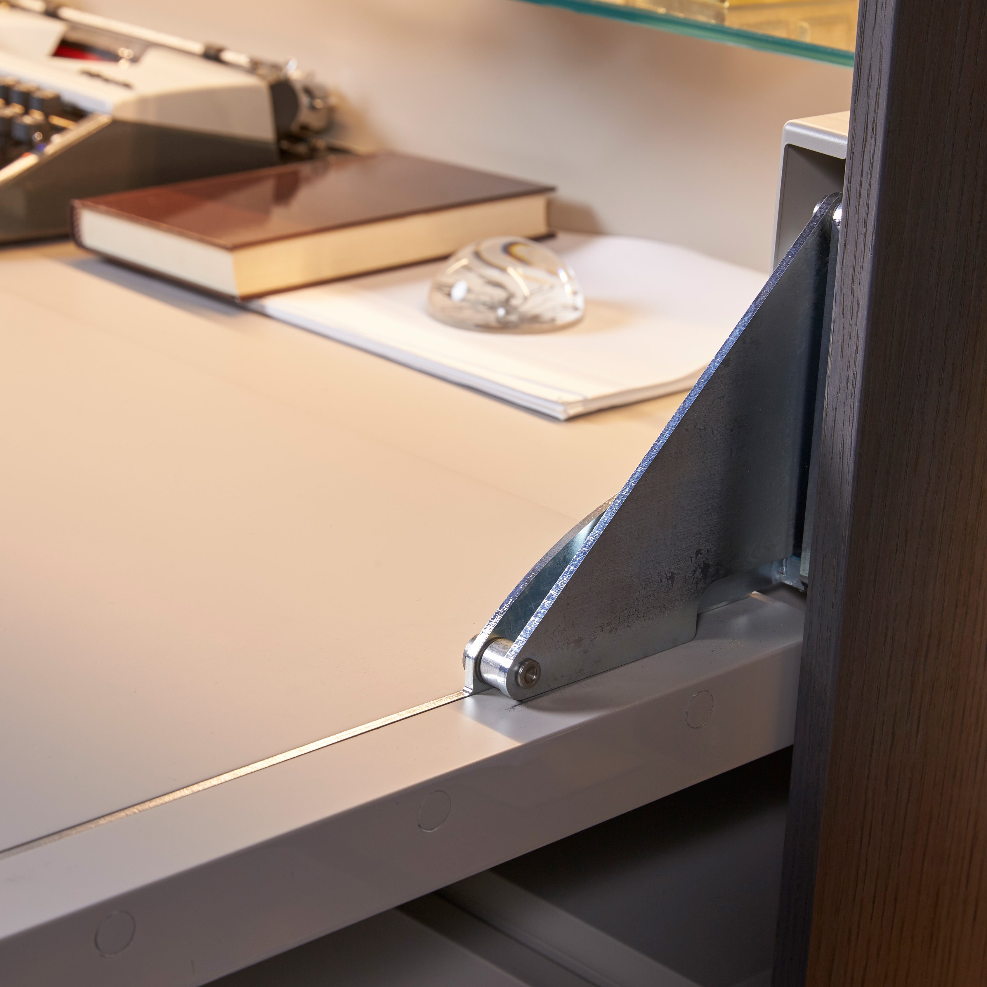 Custom cabinetry units hardware detail showing metal hinge and desk surface — modern wall-mounted furniture by Resource Furniture.
