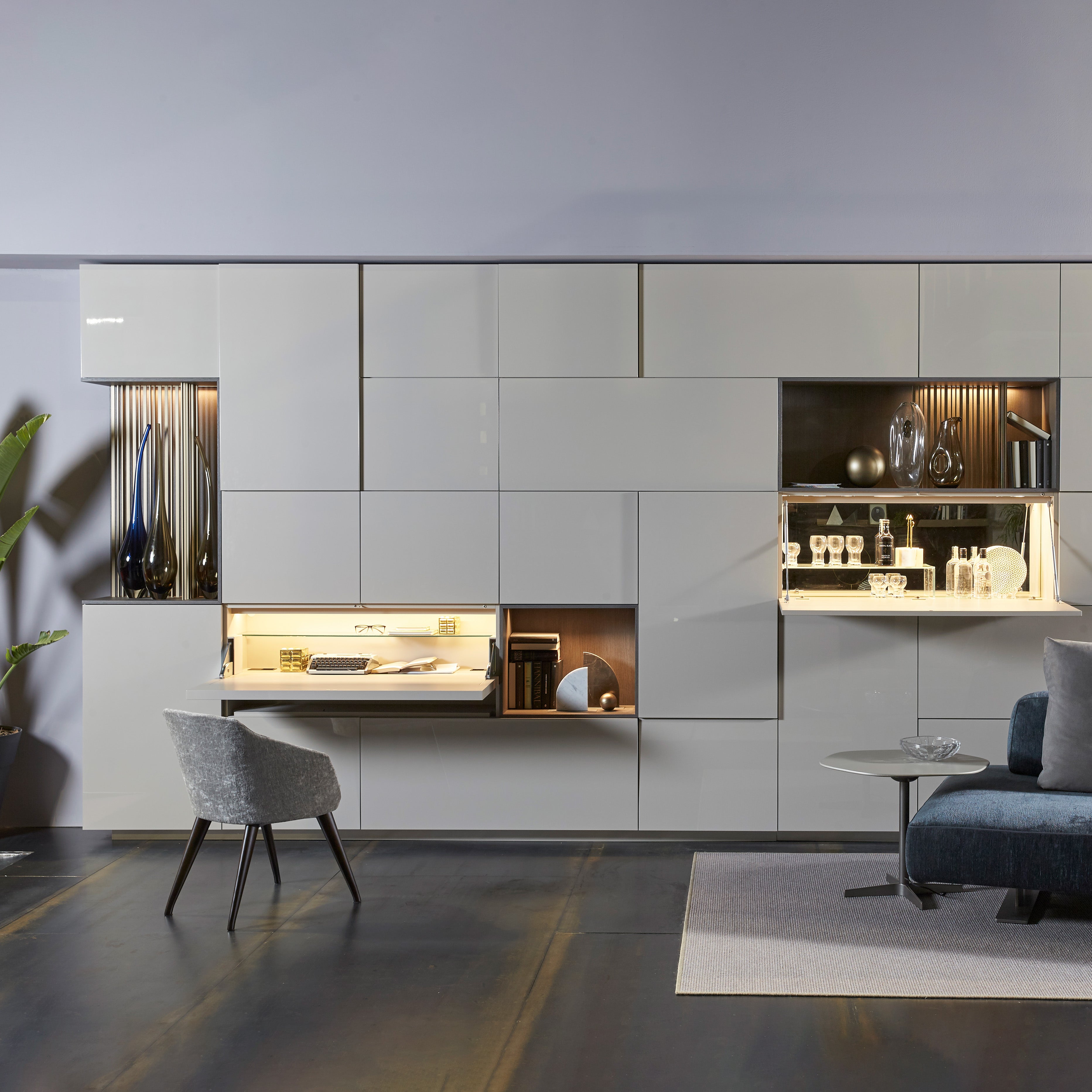 Custom cabinetry units with integrated desk, shelving, and LED lighting — wall-mounted space-saving furniture by Resource Furniture.