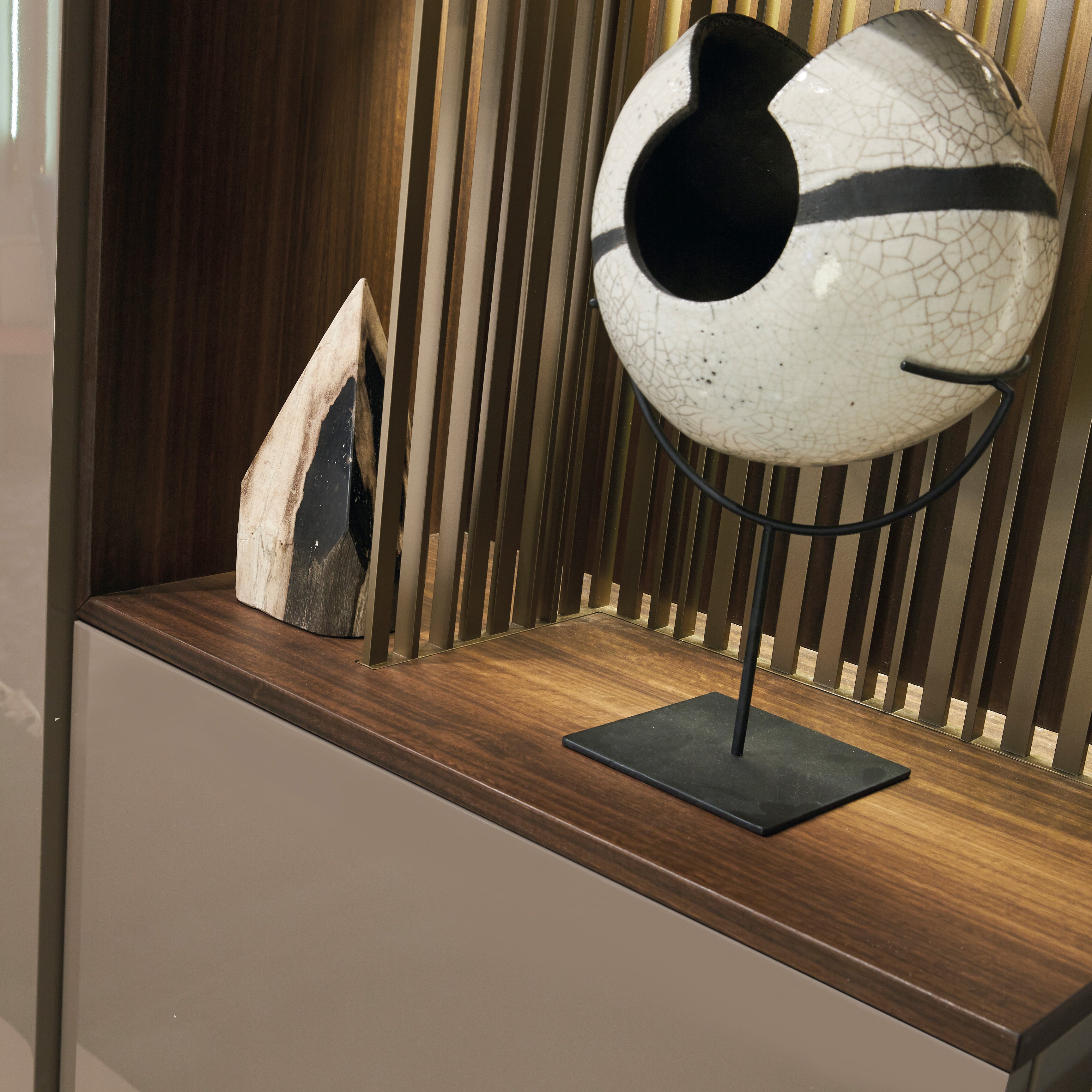 Custom cabinetry units wood shelf detail with decorative sculpture and accent lighting — modern wall-mounted furniture by Resource Furniture.