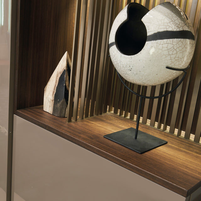 Custom cabinetry units wood shelf detail with decorative sculpture and accent lighting — modern wall-mounted furniture by Resource Furniture.