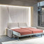 Ella & Louis freestanding queen wall bed with sofa, shown fully extended as a queen-sized bed with rust-colored bedding.