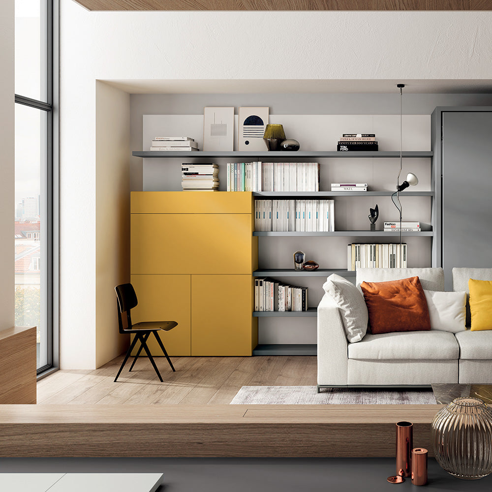 Bright yellow home office wall-mounted desk and shelving system next to a Tonale sectional murphy bed, combining workspace and multifunctional living in a small space.