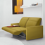 Ito wall bed in closed position with reclining sofa in green upholstery, styled with a rust-colored throw and books in a minimalist room.