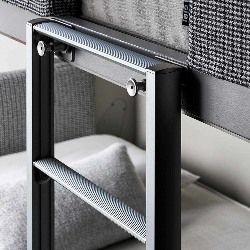 Close-up of the Kali Duo Desk ladder safety locking mechanism mounted against herringbone fabric upholstery, showcasing thoughtful design and secure bunk bed access.