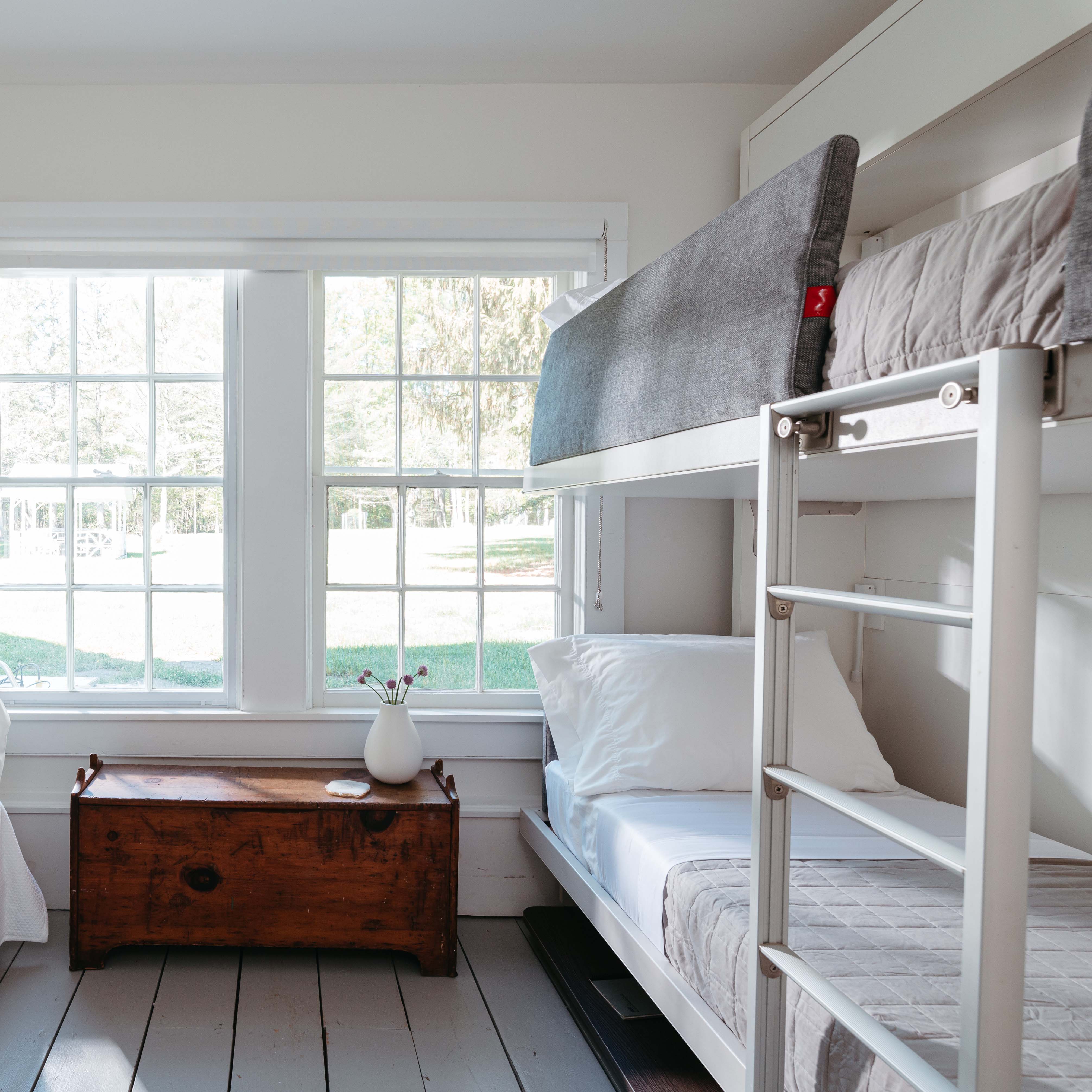 Kali Duo Desk Murphy bunk bed with desk shown in angled view, featuring upholstered side panel and built-in ladder for top bunk access.