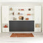 Kali horizontal twin Murphy bed in the closed position with dark front panel, built into a custom wall unit with open shelves and storage cabinets.