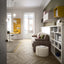 Modern living and working space featuring the Kali Sofa twin wall bed with integrated couch, surrounded by custom shelving and a fold-down yellow desk.
