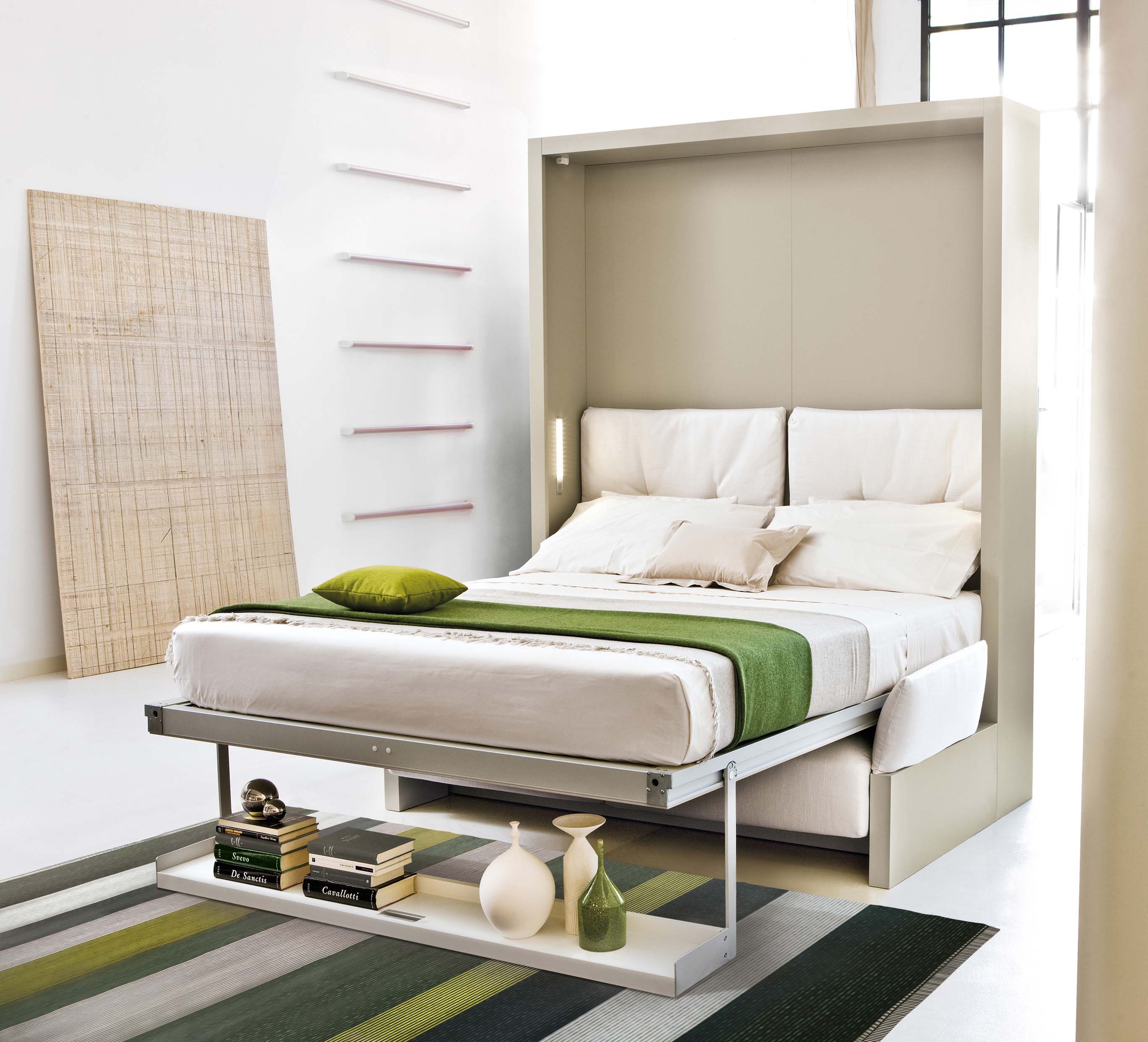 Nuovoliola queen wall bed fully extended into sleeping position with integrated shelf and modern cushioning; ideal space-saving furniture for small homes.