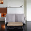 Nuovoliola wall bed system with backrest cushions flipped up, transitioning from sofa to bed.