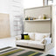 Nuovoliola wall bed in closed position with modern sofa and floating shelf, styled with books and decor.