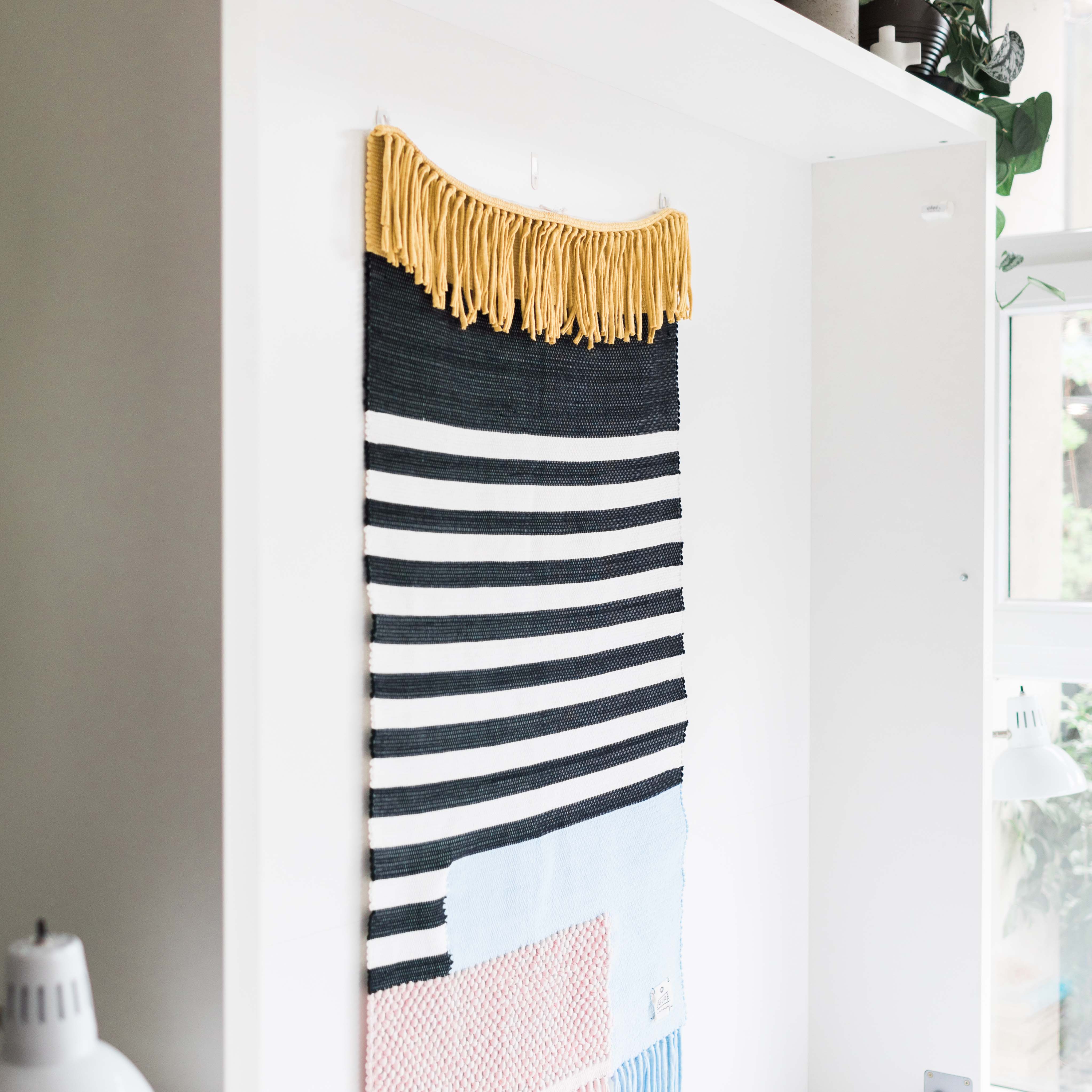 Close-up of the Penelope queen Murphy bed interior panel with custom textile hanging, perfect for maximizing wall storage in small spaces.