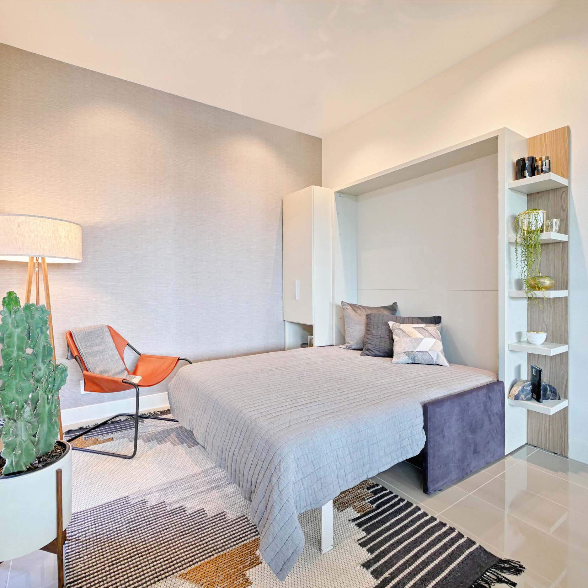 Penelope Sofa Queen Murphy bed open with upholstered headboard and deep purple sofa base in a modern, space-saving living room.