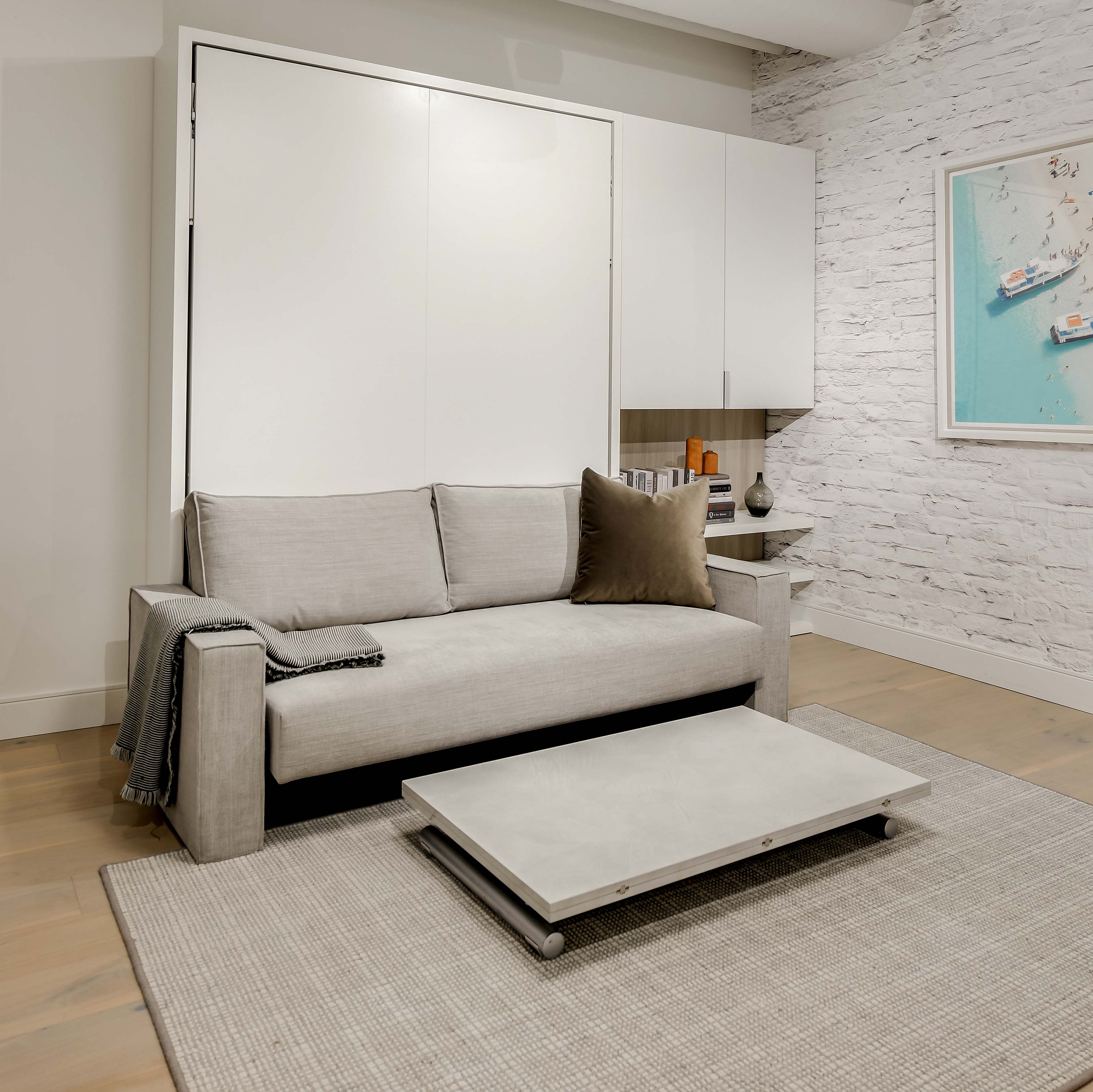 Penelope Sofa Murphy bed in closed sofa configuration at Resource Furniture’s New York showroom, showcasing space saving furniture with modern design.