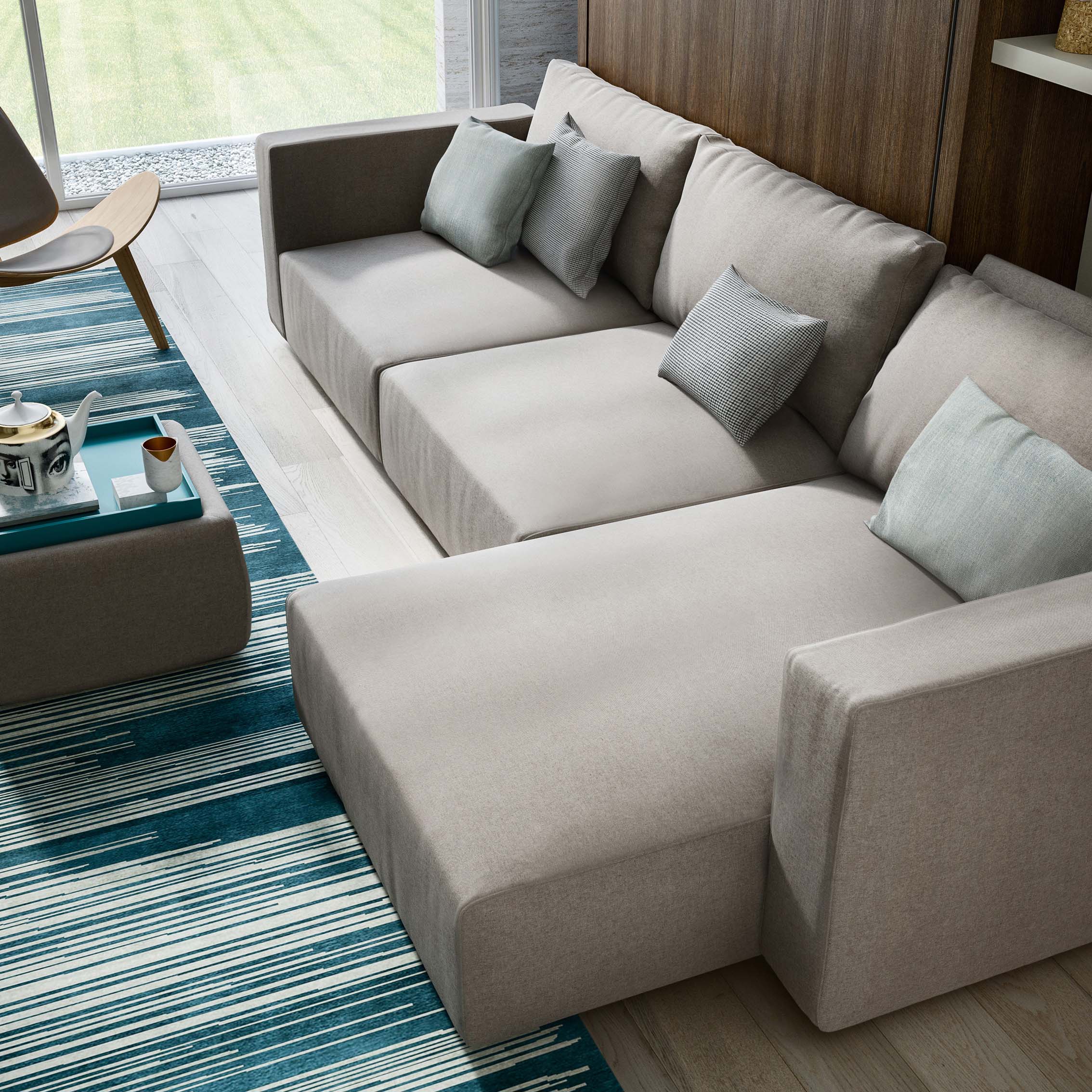Murphy bed with integrated chaise lounge shown open in a multifunctional space-saving layout.