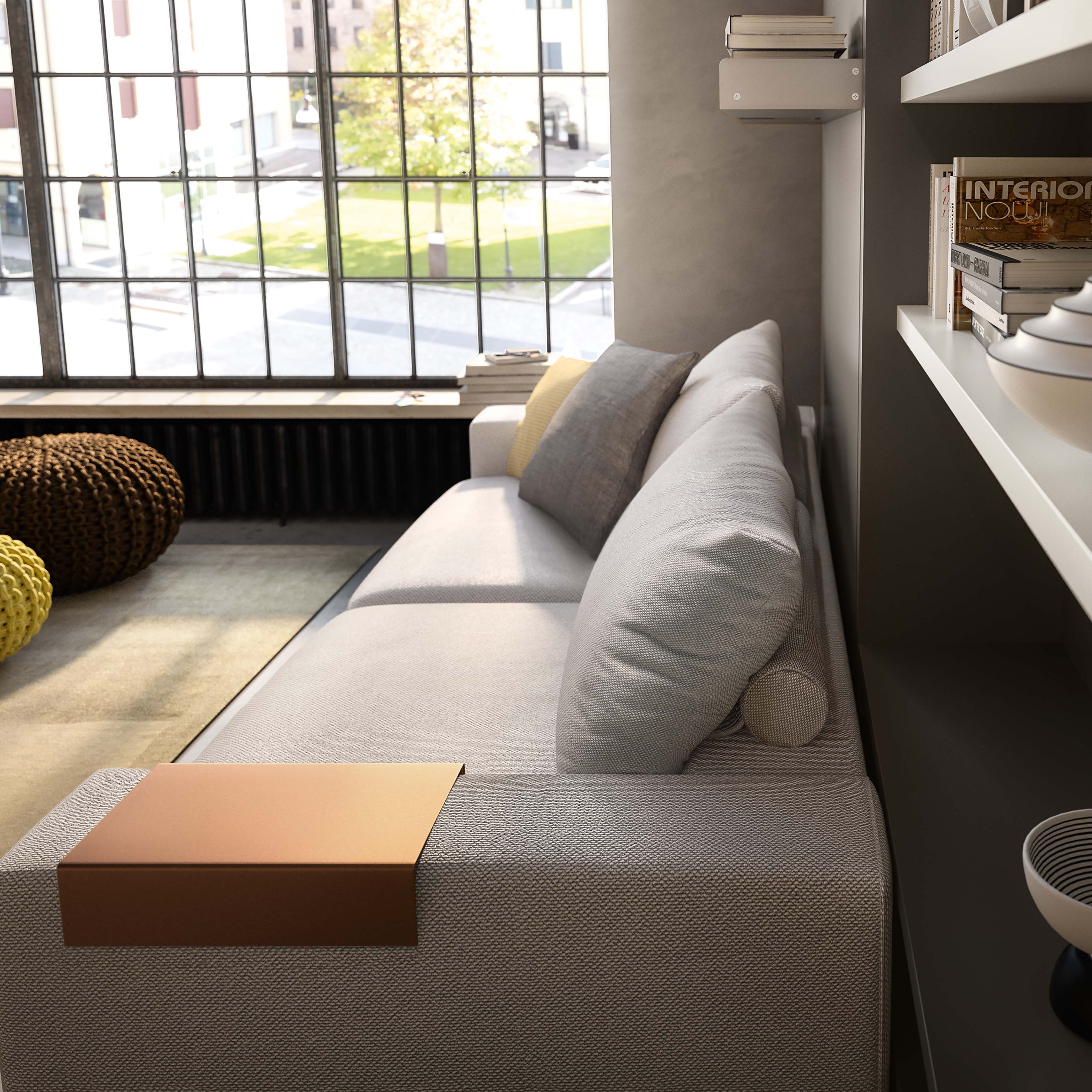 Close-up view of the Tango sofa armrest and cushions in a contemporary loft, designed for space-saving interiors and seamless integration with wall bed systems.